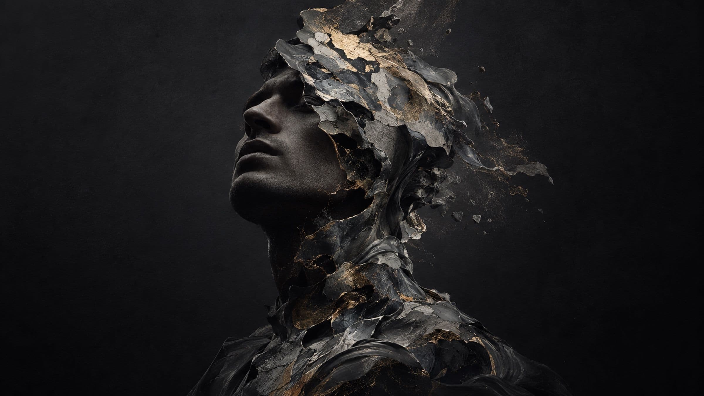A face sculpted from dark, fractured stone, turned upward.